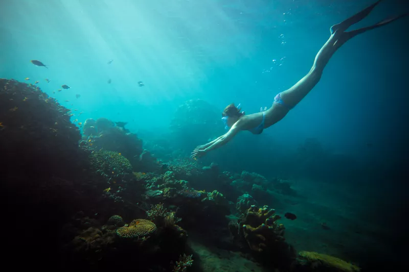 Woman swimming in deep waters of Indian Ocean