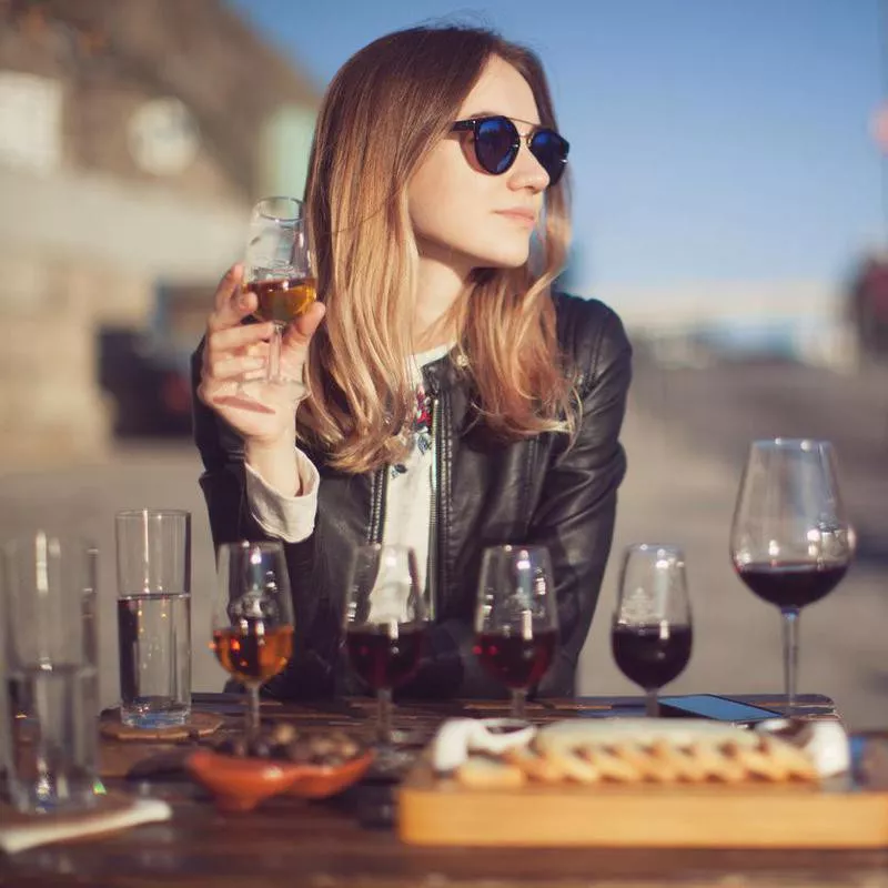 Woman with wine testing glasses