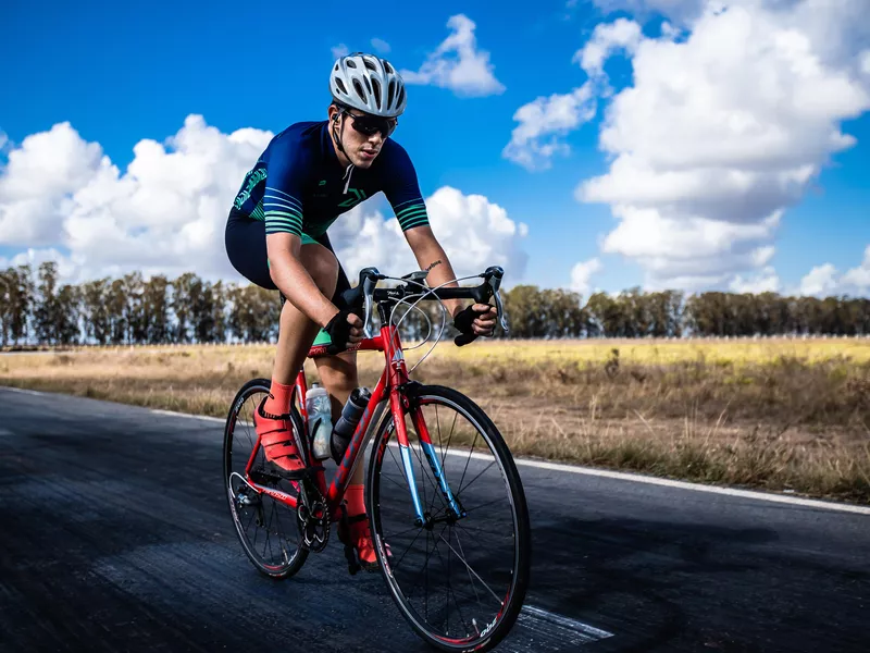 Man riding a bicycle on an open highway