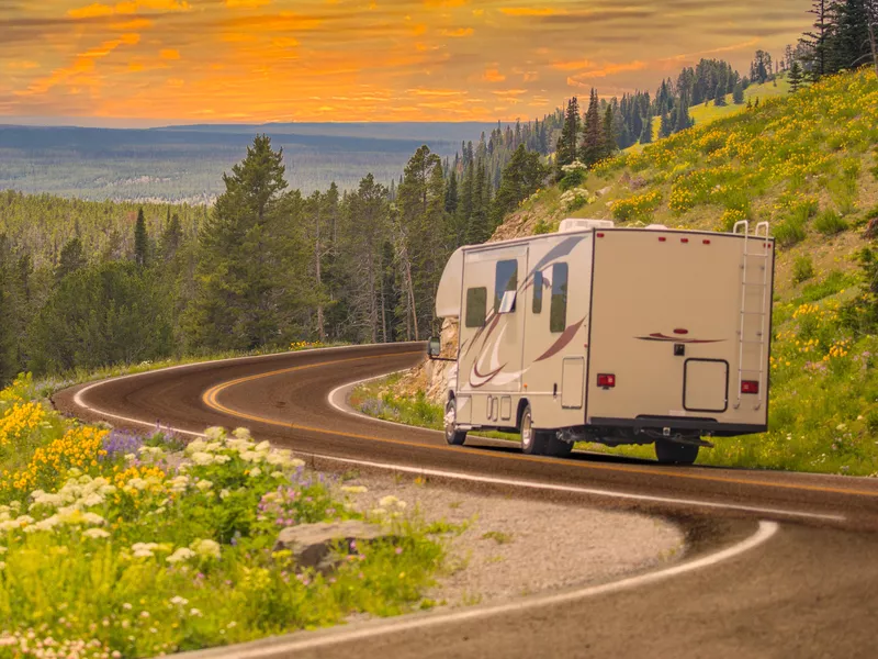 Camper driving down road on a beautiful mountain