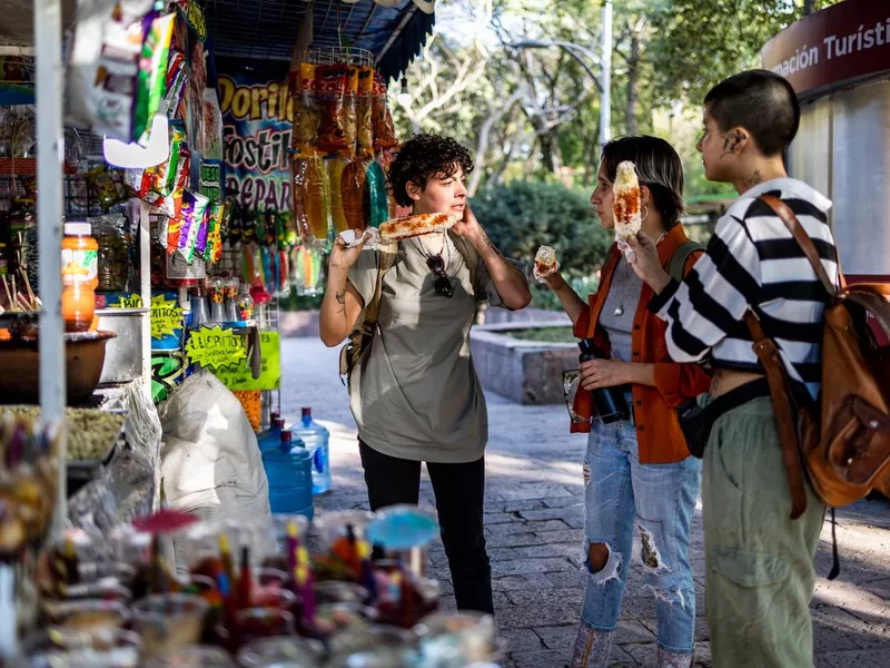 Tourists buying food at a city food stand