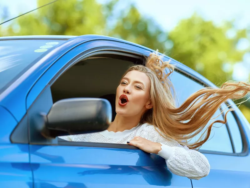 Woman driving a blue car