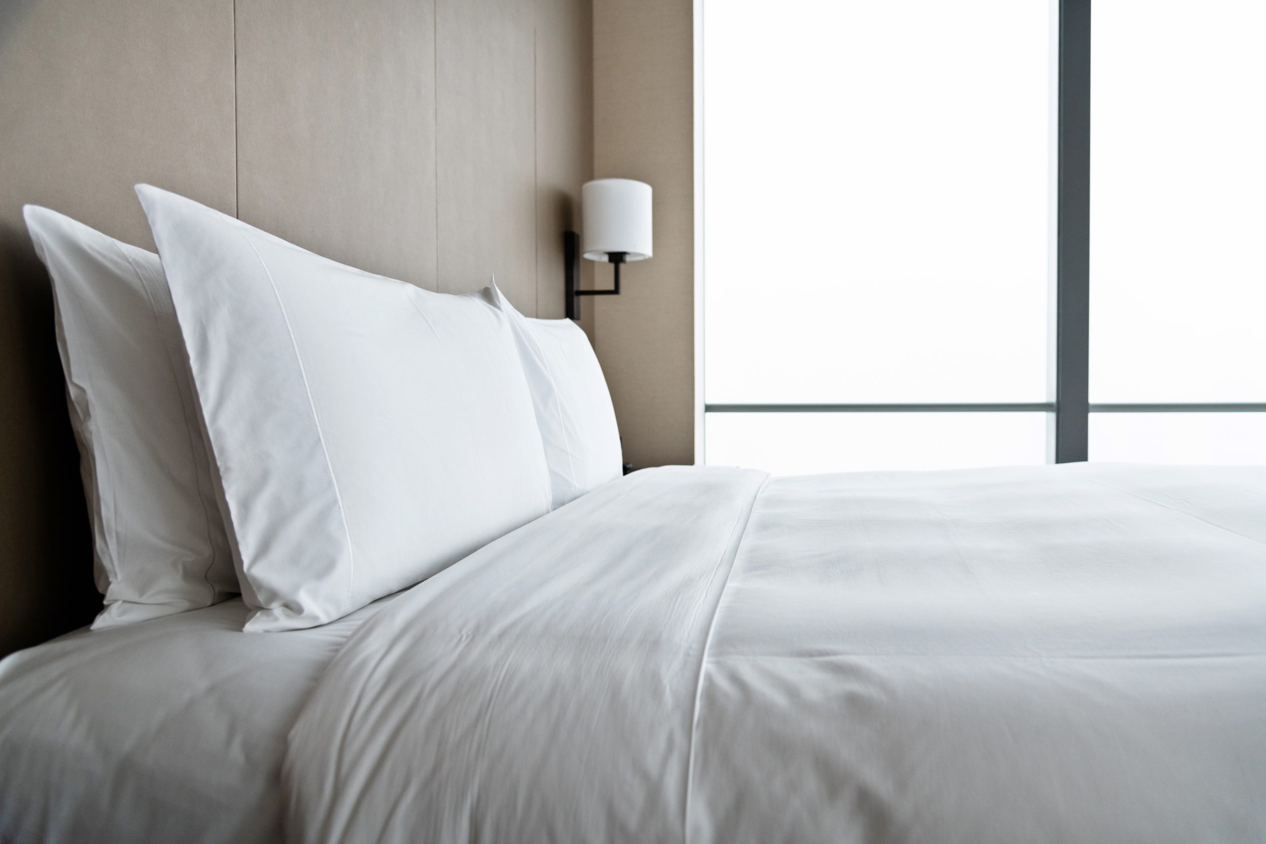Modern bedroom with white bed.