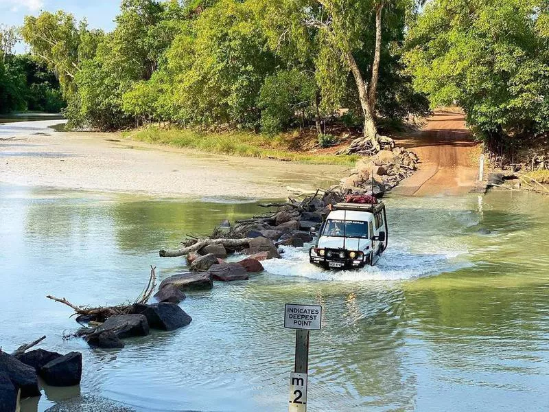 Car passing through Cahills Crossing in East Alligator River