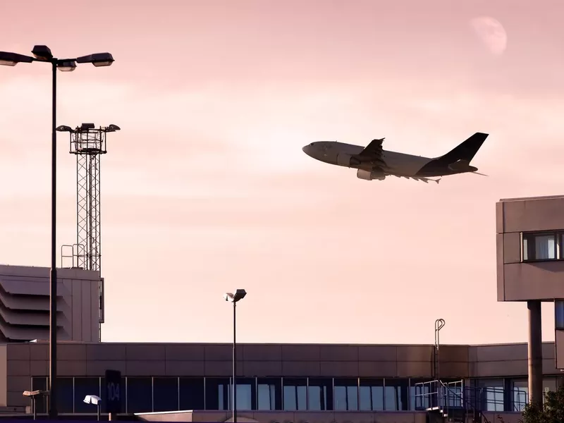 cargo jet taking off at dusk.