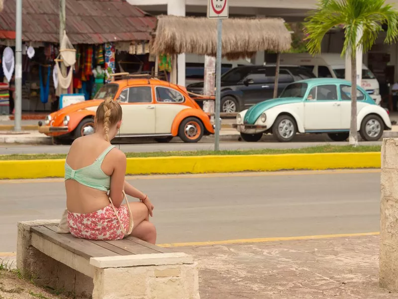 People walking on the sidewalk on Avenida Tulum.