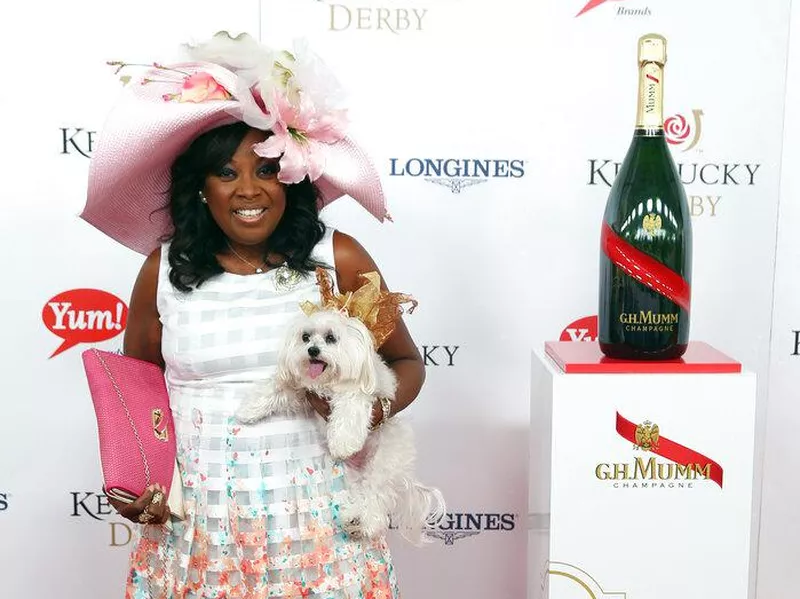 Star Jones in a Kentucky Derby hat with a dog in a hat