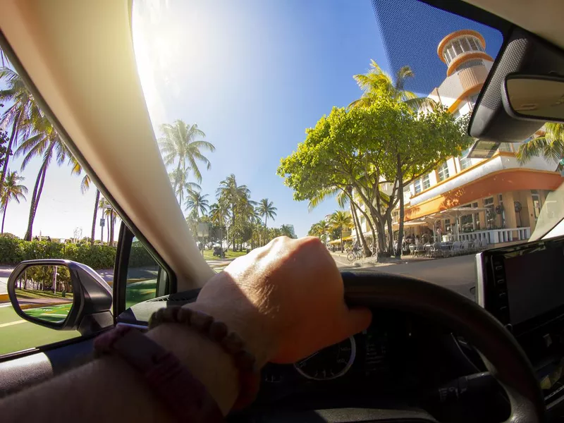 man driving car in miami