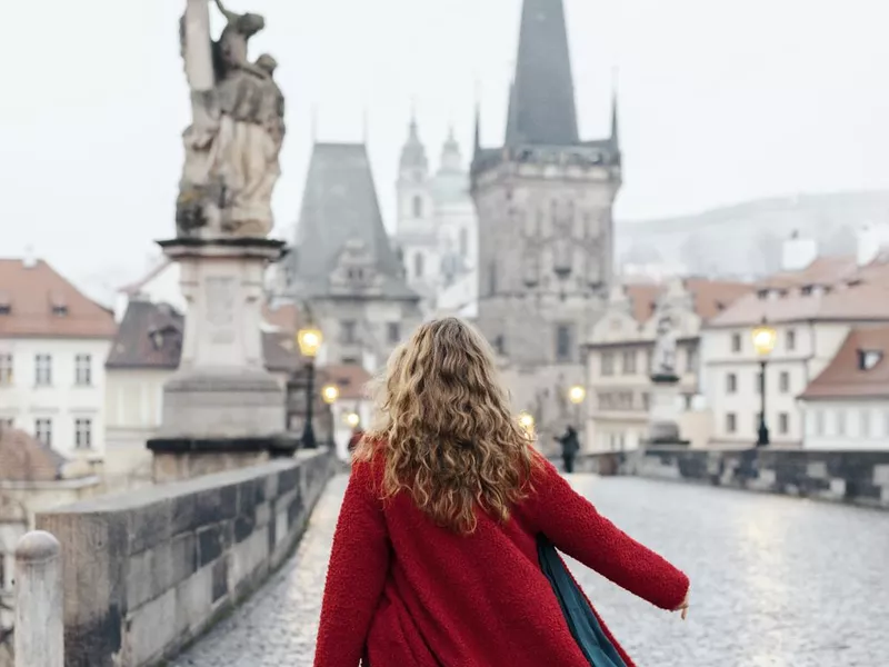 Traveler on Prague's Charles Bridge