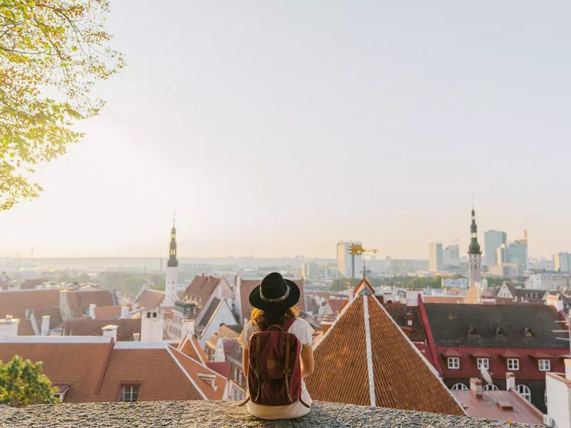 Woman sitting and looking at Tallinn in the morning