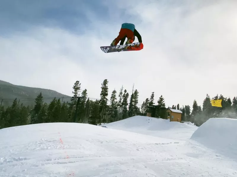 A Snowboarder jumping at Eldora Ski Resort