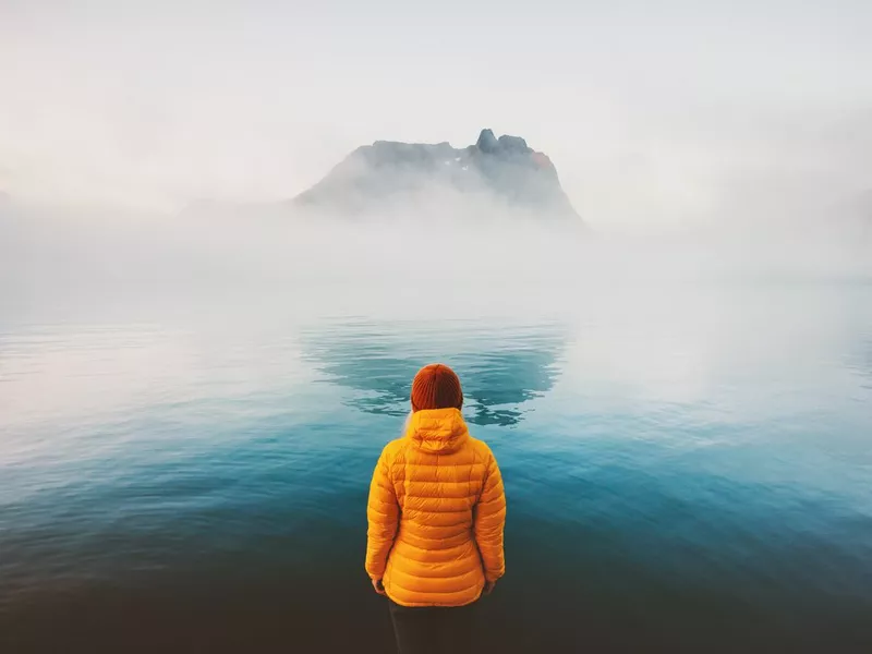 Women traveling alone by lake