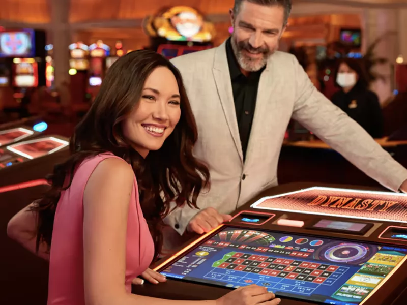 Woman and man playing Dynasty Games at Encore Boston Harbor