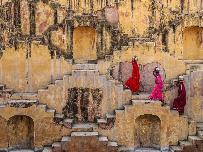 Indian women carrying water from stepwell near Jaipur