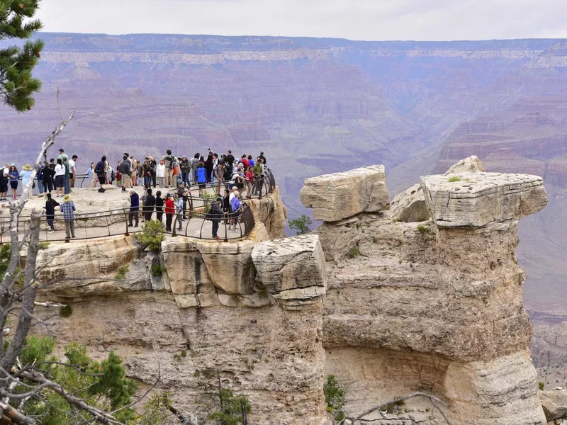 Tourists overlook the Grand Canyon from Mather Point tourist stop in the South Rim of the Grand Canyon National Park. Arizona, Usa, America.