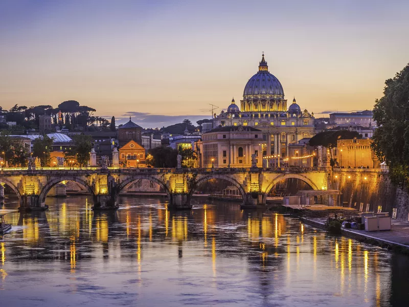 Rome sunset over Tiber and St. Peters Basilica at the Vatican in Italy