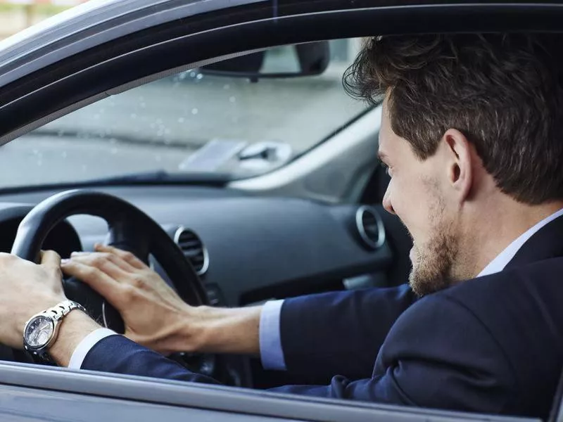 Aggressive driver in car, side view