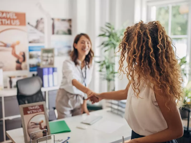 Woman arriving in travel agency