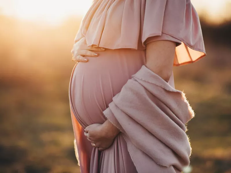 Pregnant woman in a dusty pink dress