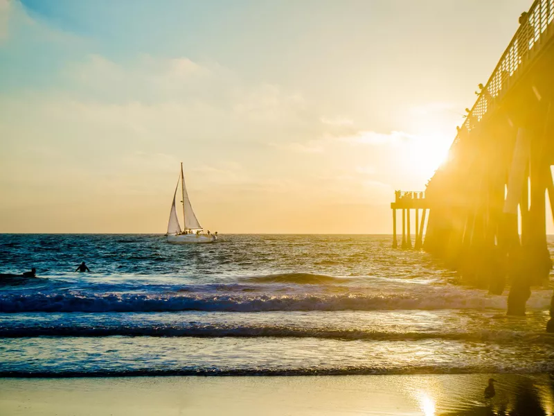 Sailboat at sunset at Hermosa Beach Pier