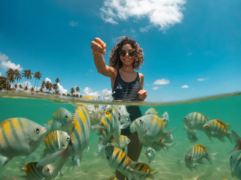 Woman in the beach with fish