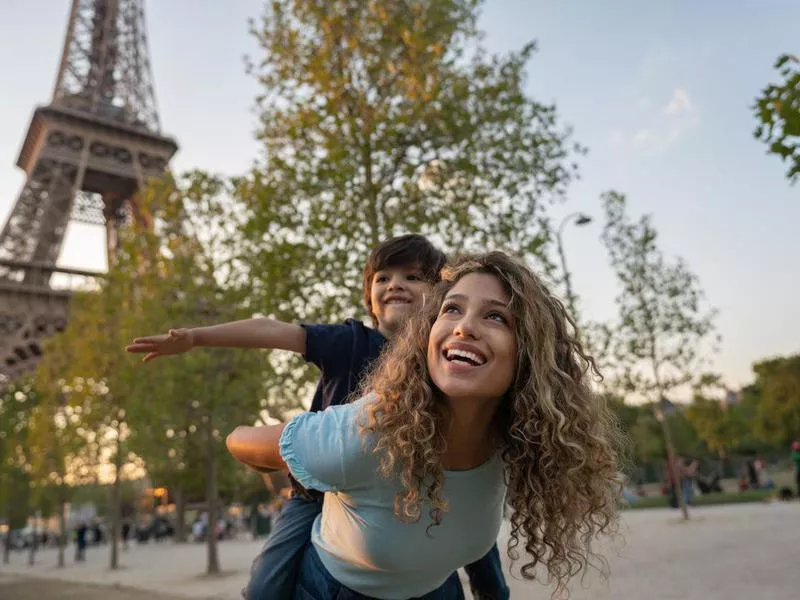 Happy mother and son traveling to Paris