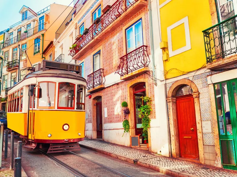 Yellow vintage tram on the street in Lisbon, Portugal