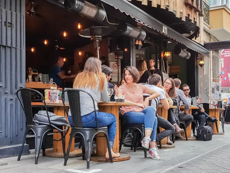 People sitting at the bar in the Kadikoy district of Istanbul city