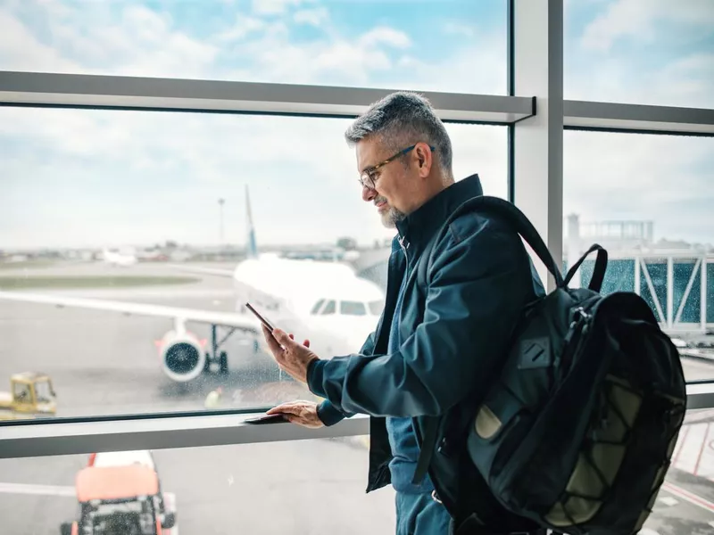 Man waiting for his flight in airport lounge