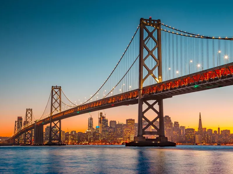 San Francisco skyline with Oakland Bay Bridge at sunset, California, USA