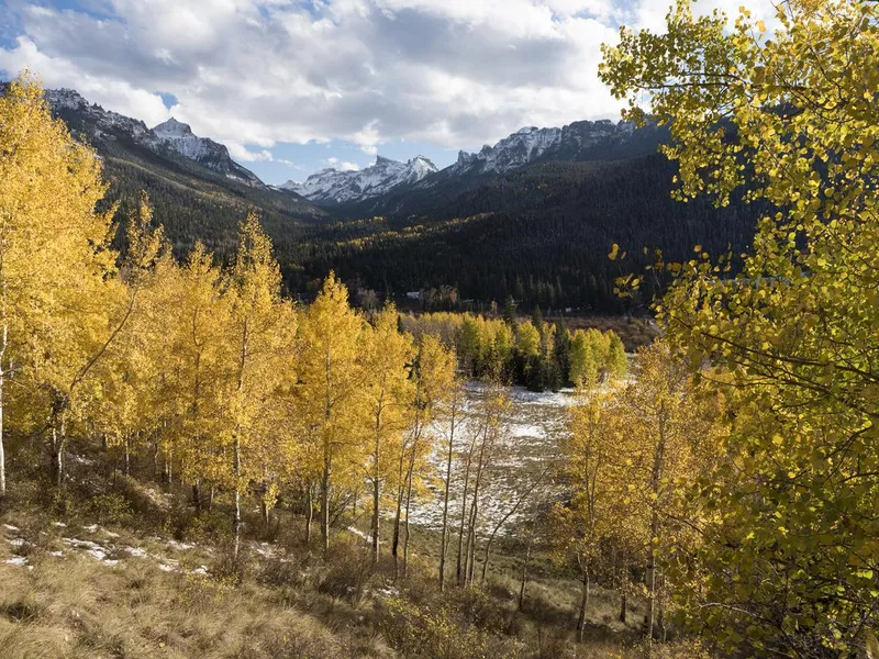 Redcliff Peak and Coxcomb Peak viewed from Cimarron River Valley after early fall snow storm