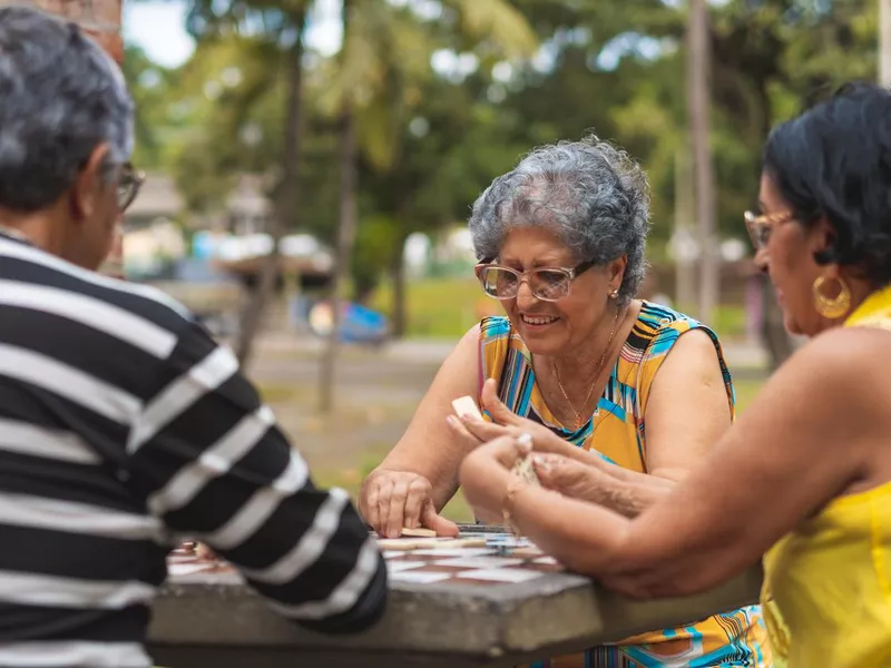 Group playing dominoes in public park