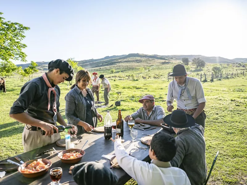 Argentine family enjoying outdoor midday meal