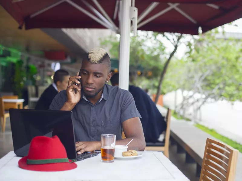 Man sitting in Medellin restaurant while checking laptop