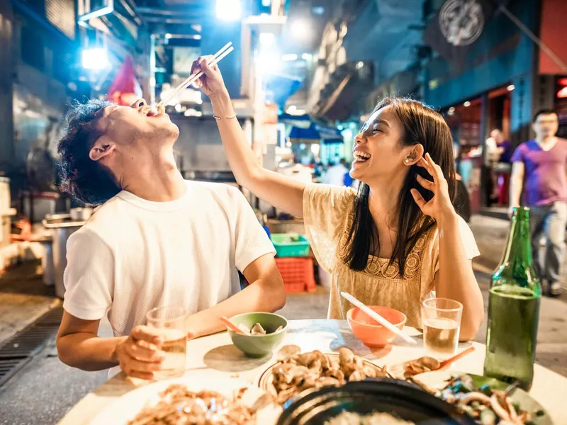 Couple enjoying street food in Hong Kong