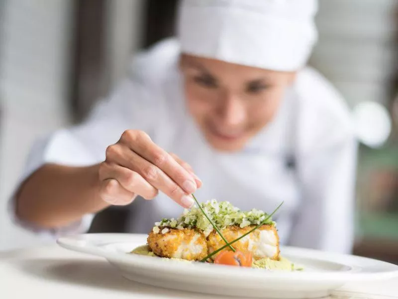 Cook decorating a plate