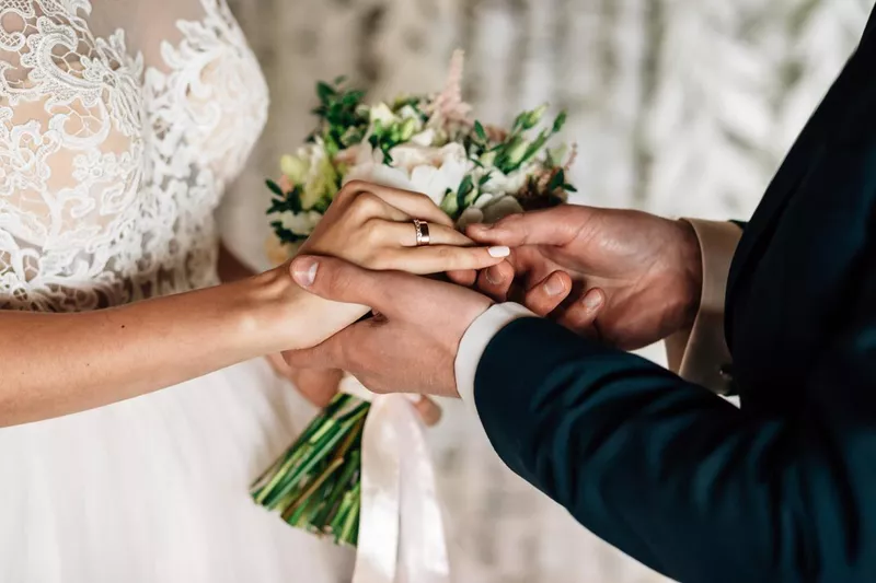 Bride and groom holding hands