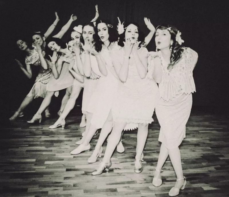 A dance group dances the Charleston dance on stage