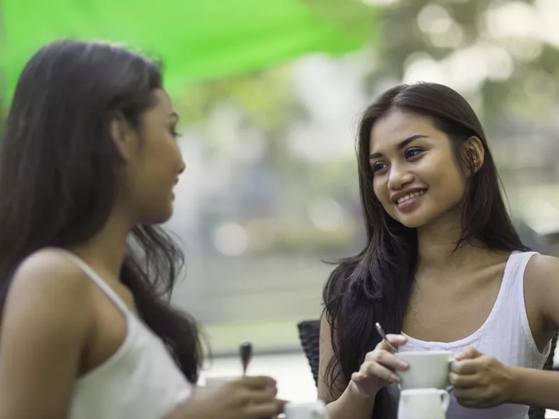 Two friends sitting at a cafe together