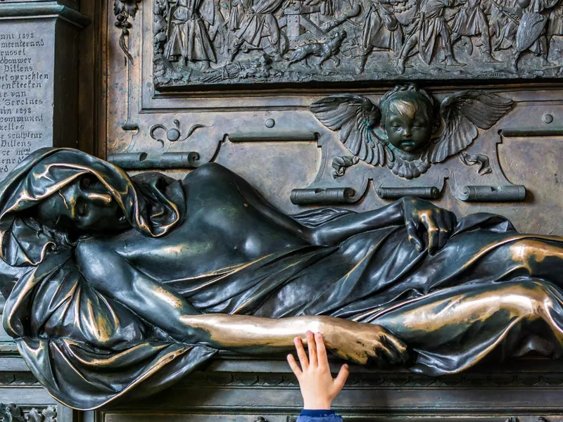 A kid's hand touching the statue of Everard t' Serclaes in Brussels, Belgium