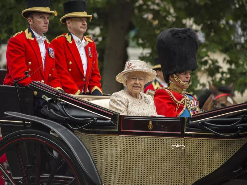 Queen Elizabeth II in an open carriage with Prince Philip