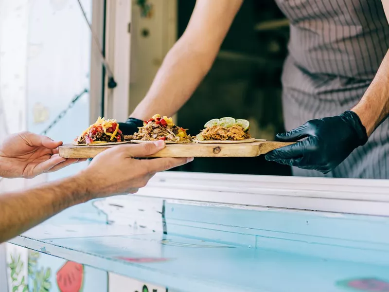 Food truck owner serving tacos