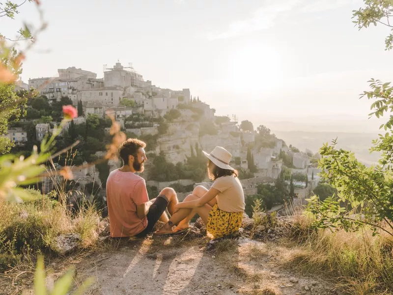 Woman and man looking at scenic view of Gordes village in Provence