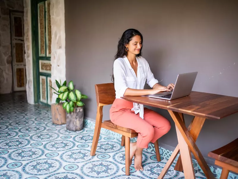 Young woman using a laptop in Playa del Carmen, Mexico