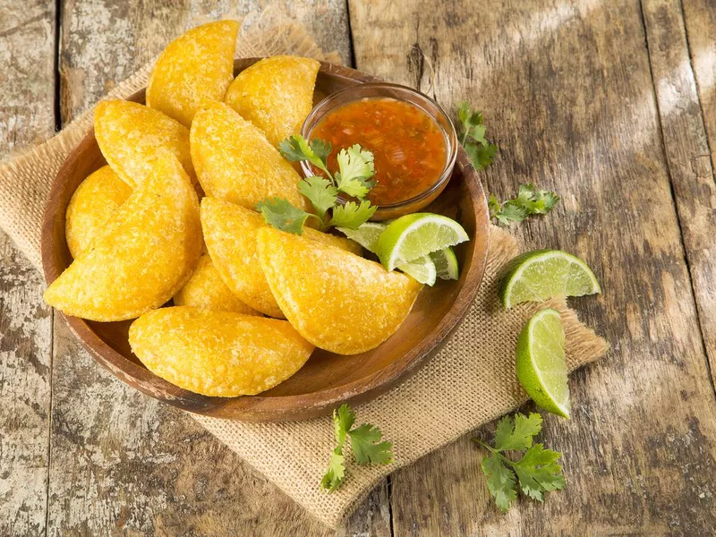 Colombian empanada with spicy sauce