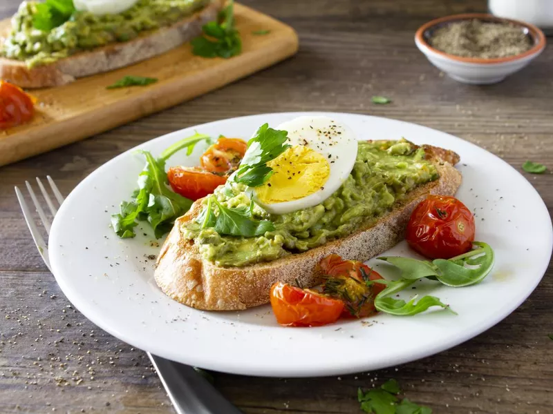 Avocado toast with eggs and roasted tomatoes