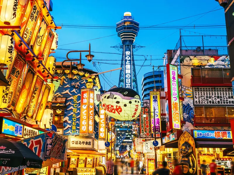 Osaka Tower and view of the neon advertisements Shinsekai district