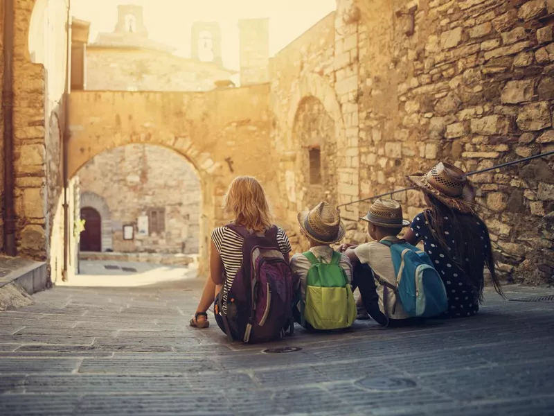 Tourists family enjoying peaceful street of small italian town