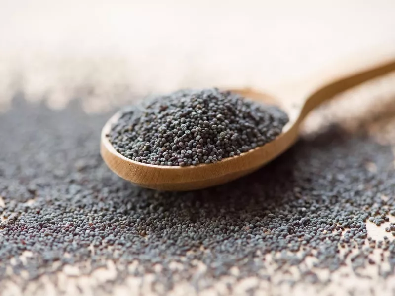 Poppy seeds in wooden spoon