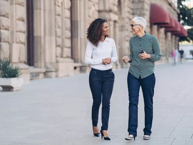 Businesswomen walking side by side on the street